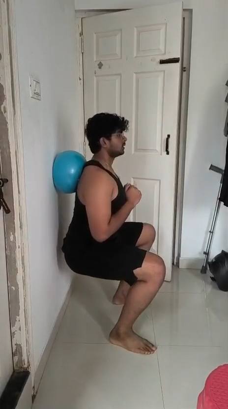 Guided wall-ball squat home exercise
